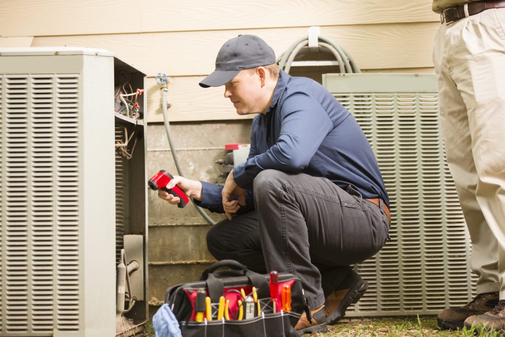 man-performing-residential-HVAC-repair-on-an-ac-unit.jpg