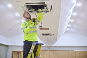 HVAC tech working on a Pittsburgh office building's air conditioner